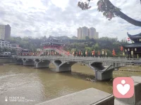 春日行至此处，被这座廊桥惊艳了时光。
青石板桥横跨河面，飞檐翘角的古楼错落有致，
红灯笼在风里轻轻晃，把春日的温柔都揉进了水波里。
抬头是新城林立，低头是古意悠悠，
一桥之隔，便是两种人间。
原来最动人的风景，从来都是古今相融的温柔。